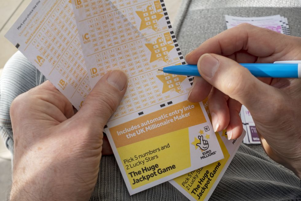 Close up of man filling in EuroMillions Lotto lottery form