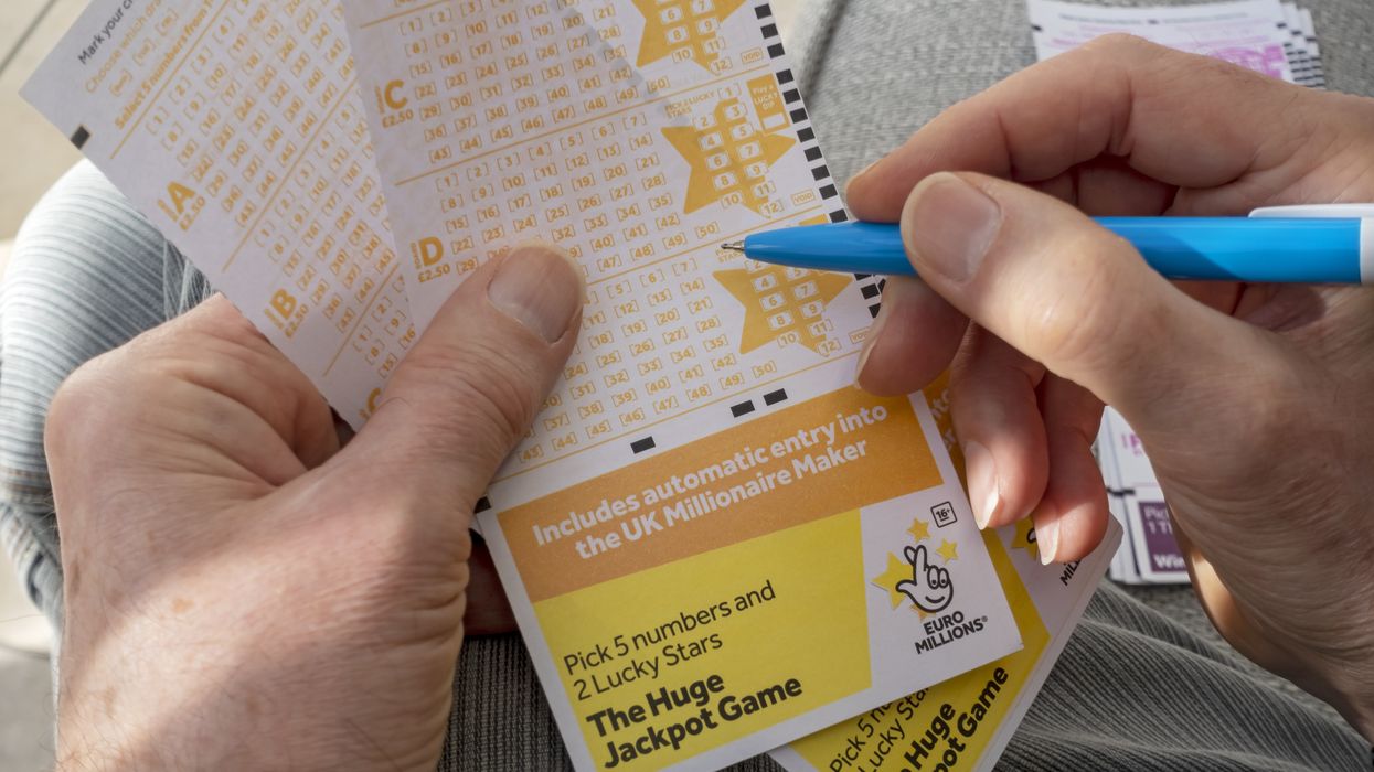 Close up of man filling in EuroMillions Lotto lottery form
