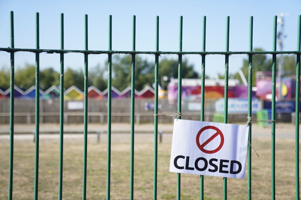 Closed signs on the gates of Liquid Leisure in Windsor, following the death of an 11-year-old girl. Emergency services were called at around 3.55pm on Saturday to reports of the child getting into difficulty at the water park near Datchet. Picture date: Sunday August 7, 2022.