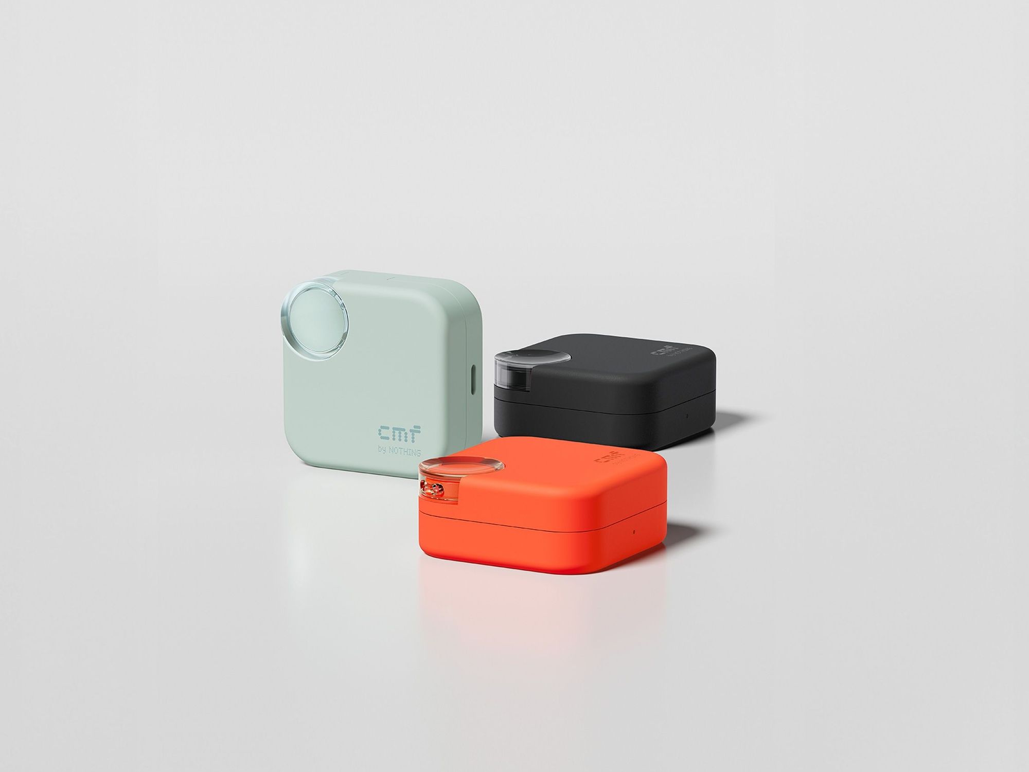 CMF Buds 2 in Orange, Dark Grey, and Light Green pictured in the charging case