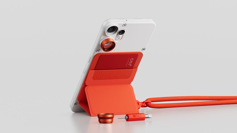 CMF Phone 2 Pro pictured with all of the new accessories in orange attached to the handset, including the lanyard, universal cover and camera cover