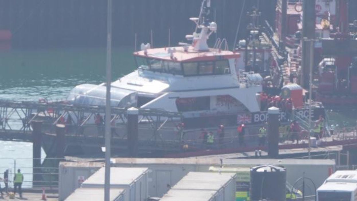 Watch as a BOATLOAD of migrants flood Dover shore and are pictured MOCKING Keir Starmer's 'crackdown'