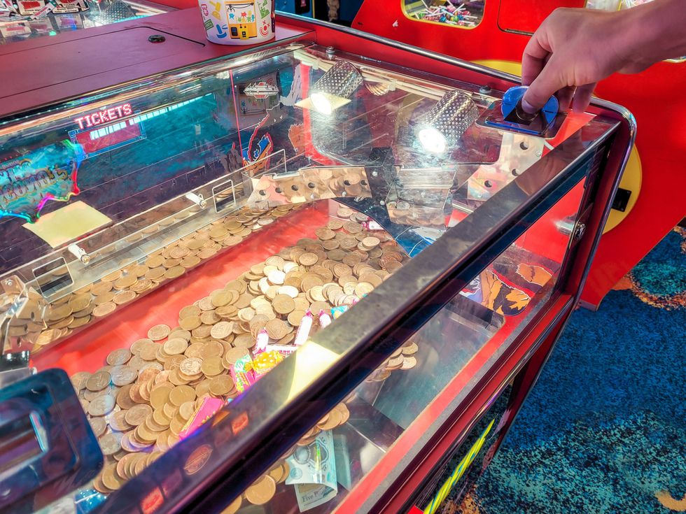 Coin pusher machine in amusement arcade