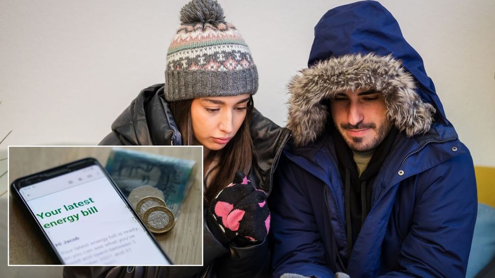 Cold couple look at energy bill