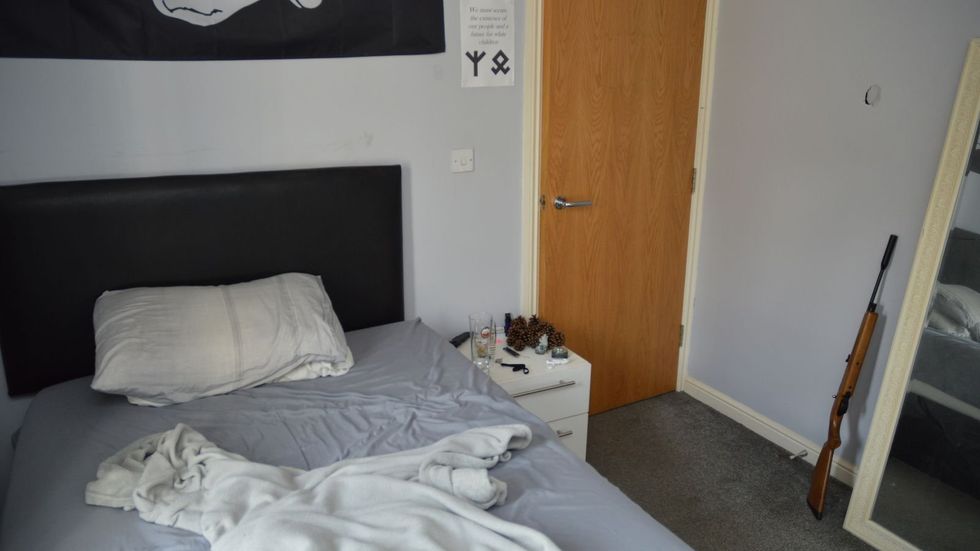 Coleman's bedroom as the police found it, with a gun in the corner of room