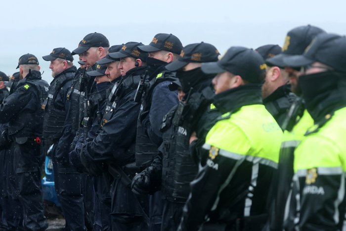 Columns of police line up against protesters at the Whitegate refinery