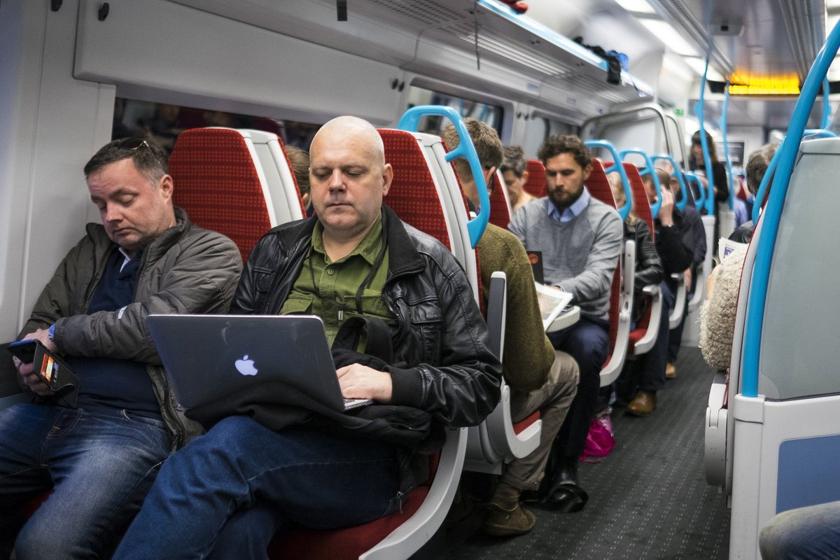 Communters use devices on train