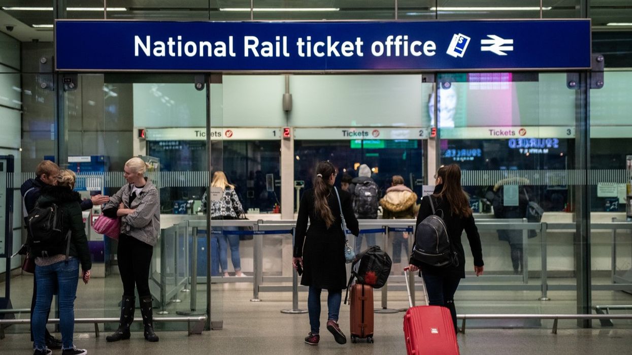 Commuters buy tickets from the ticket office
