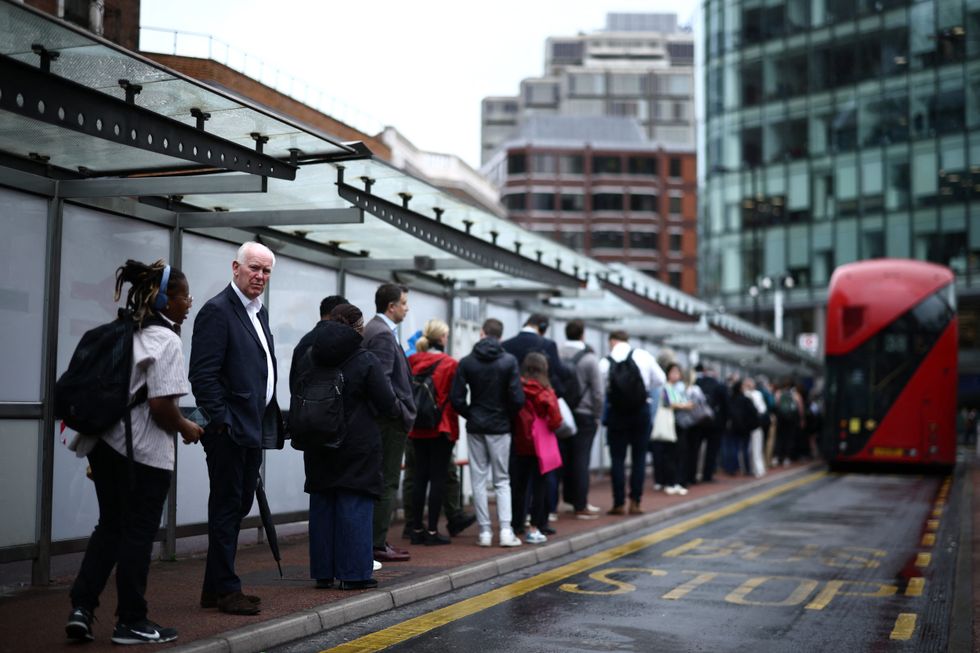 Commuters queue for double decker bus in Victoria