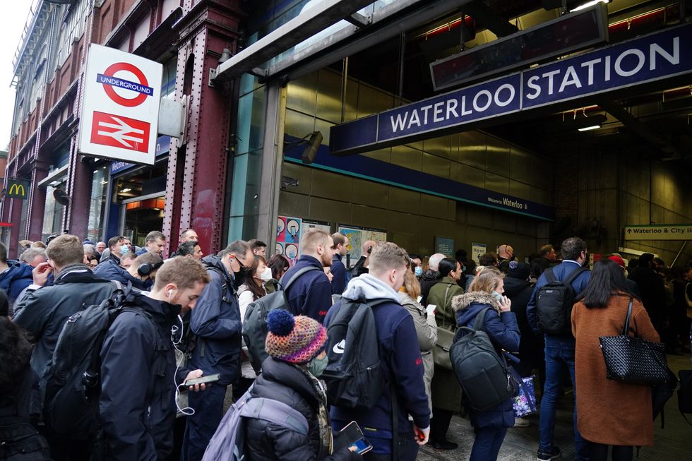 Commuters queue for the underground to resume at Waterloo station in London