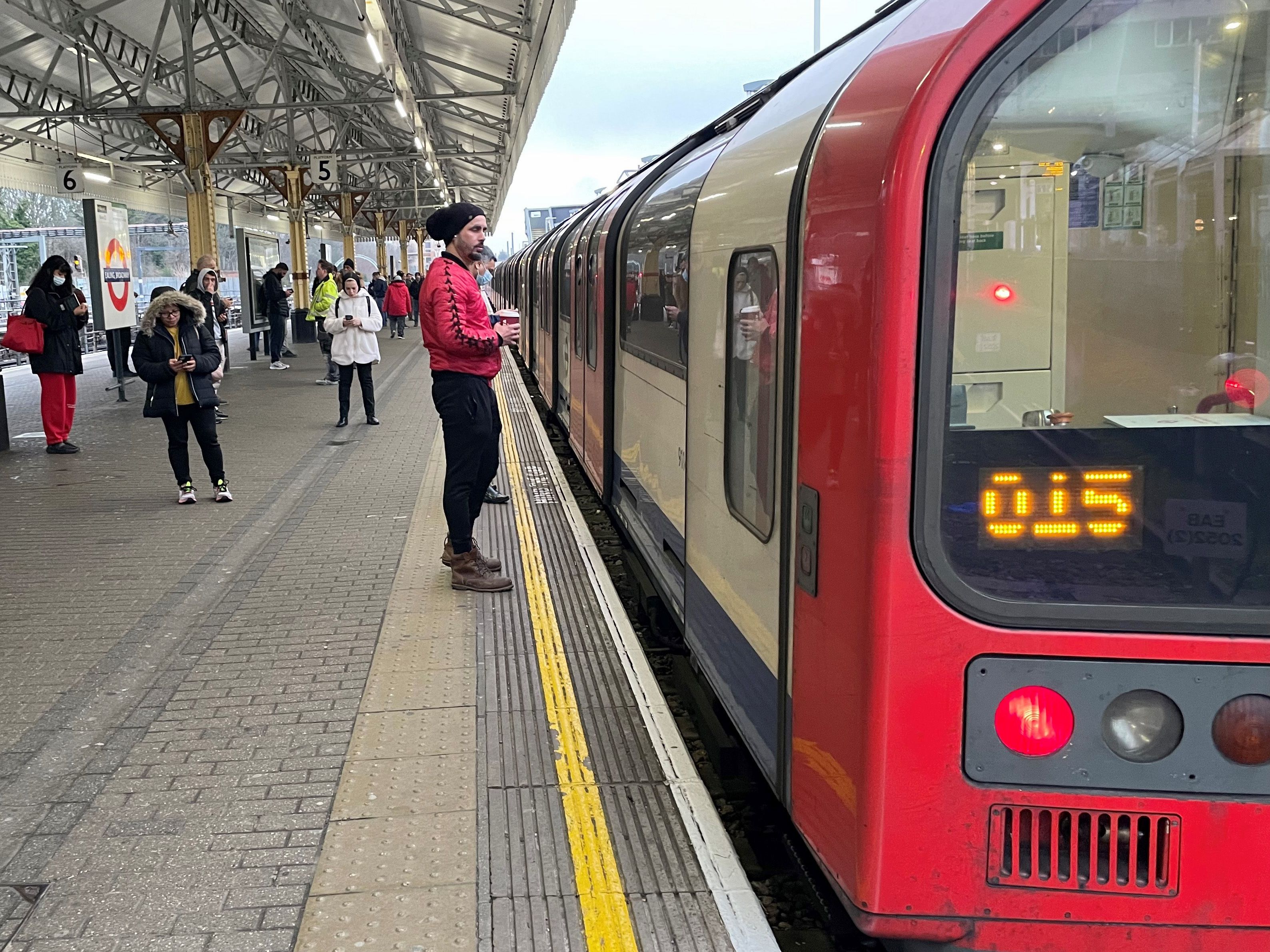 Commuters wait for a London Underground train in the capital