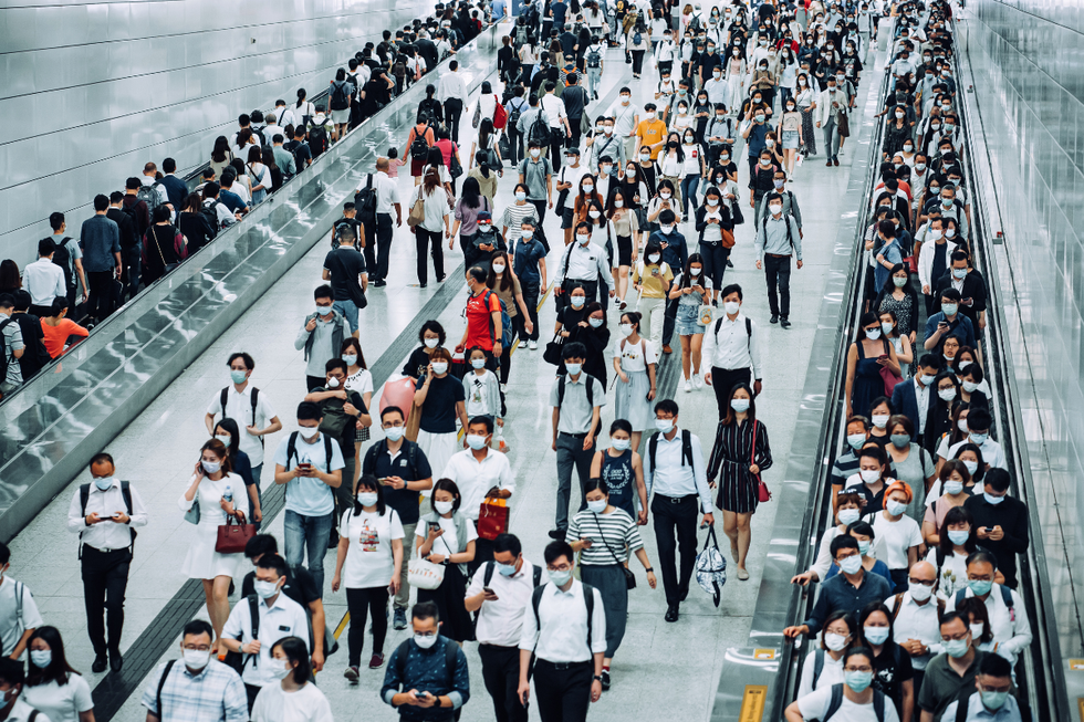 Commuters wearing masks along subway