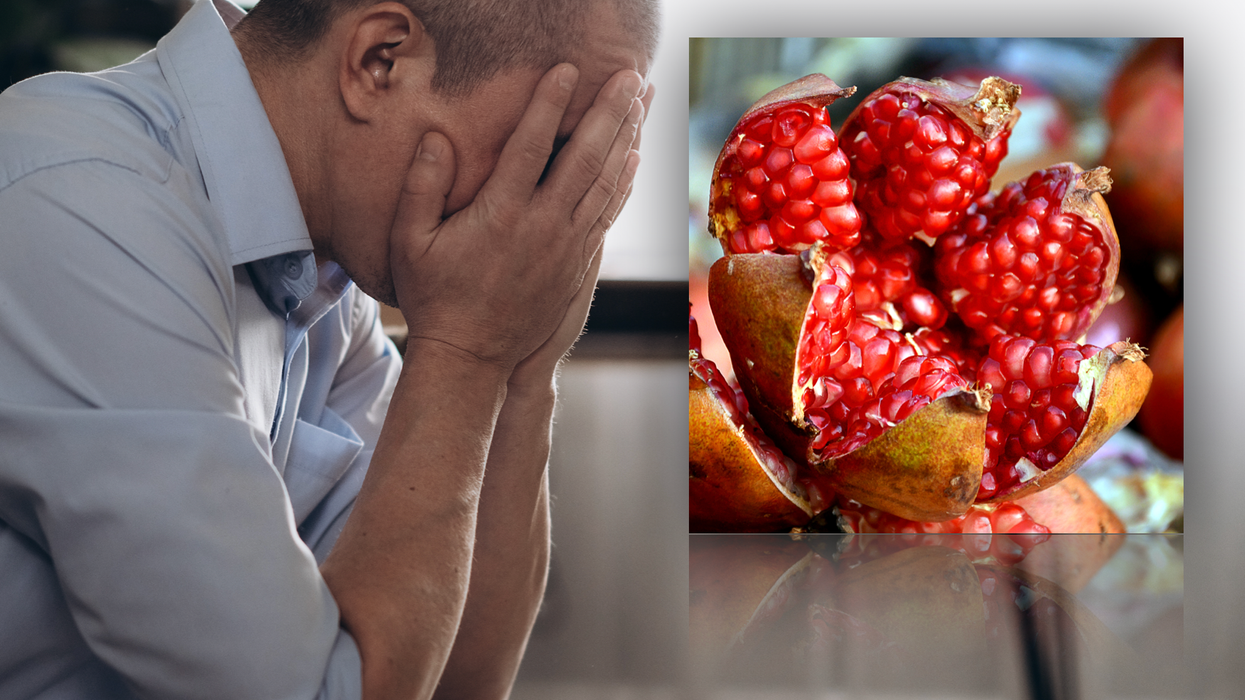 Composite image of man holding head in hands and pomegranate fruit