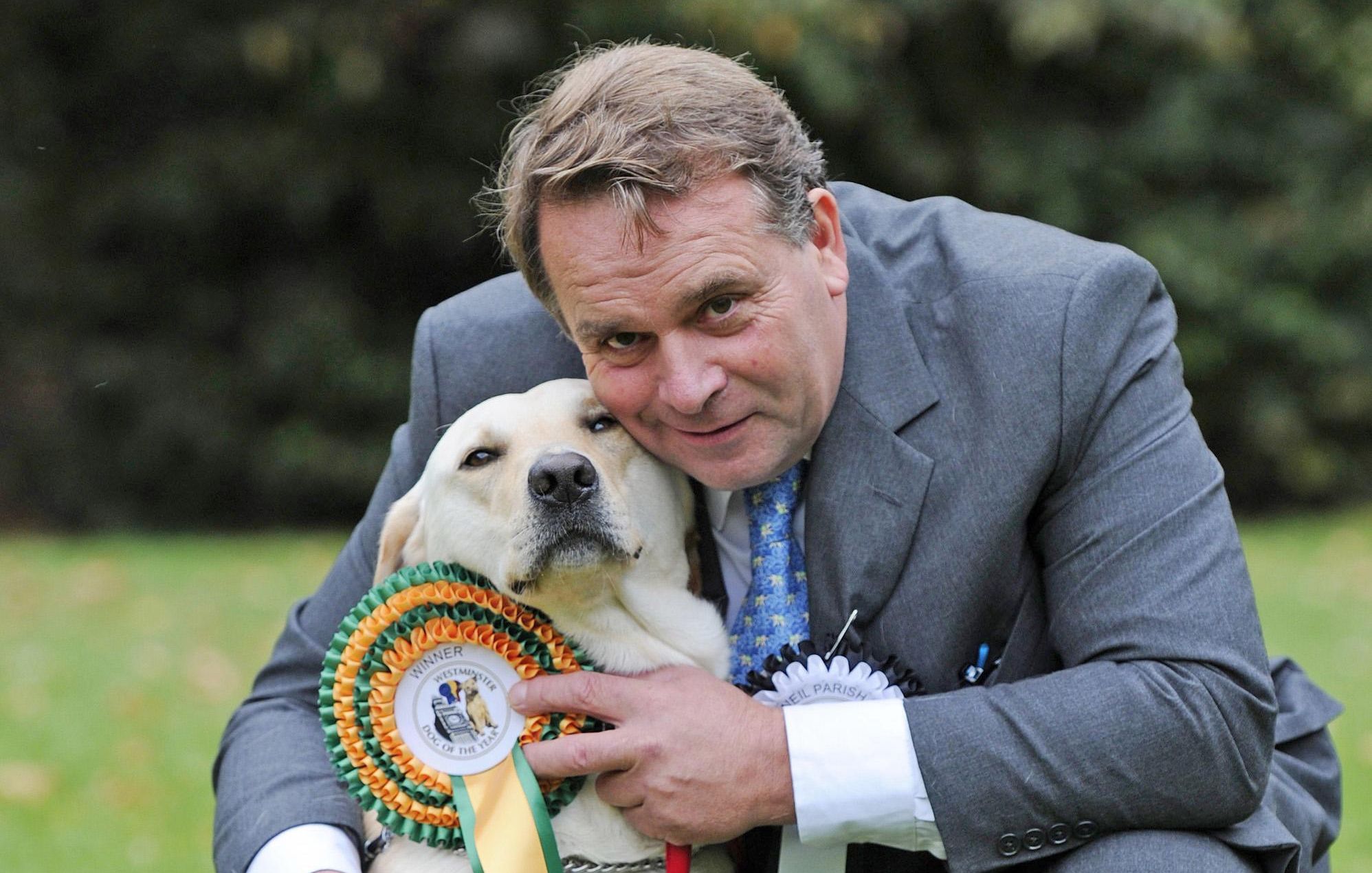 Conservative MP for Tiverton and Honiton Neil Parish and his 4-year-old Labrador Wilberforce, the winner of the Westminster Dog of the Year competition pictured at Victoria Tower Gardens in London.