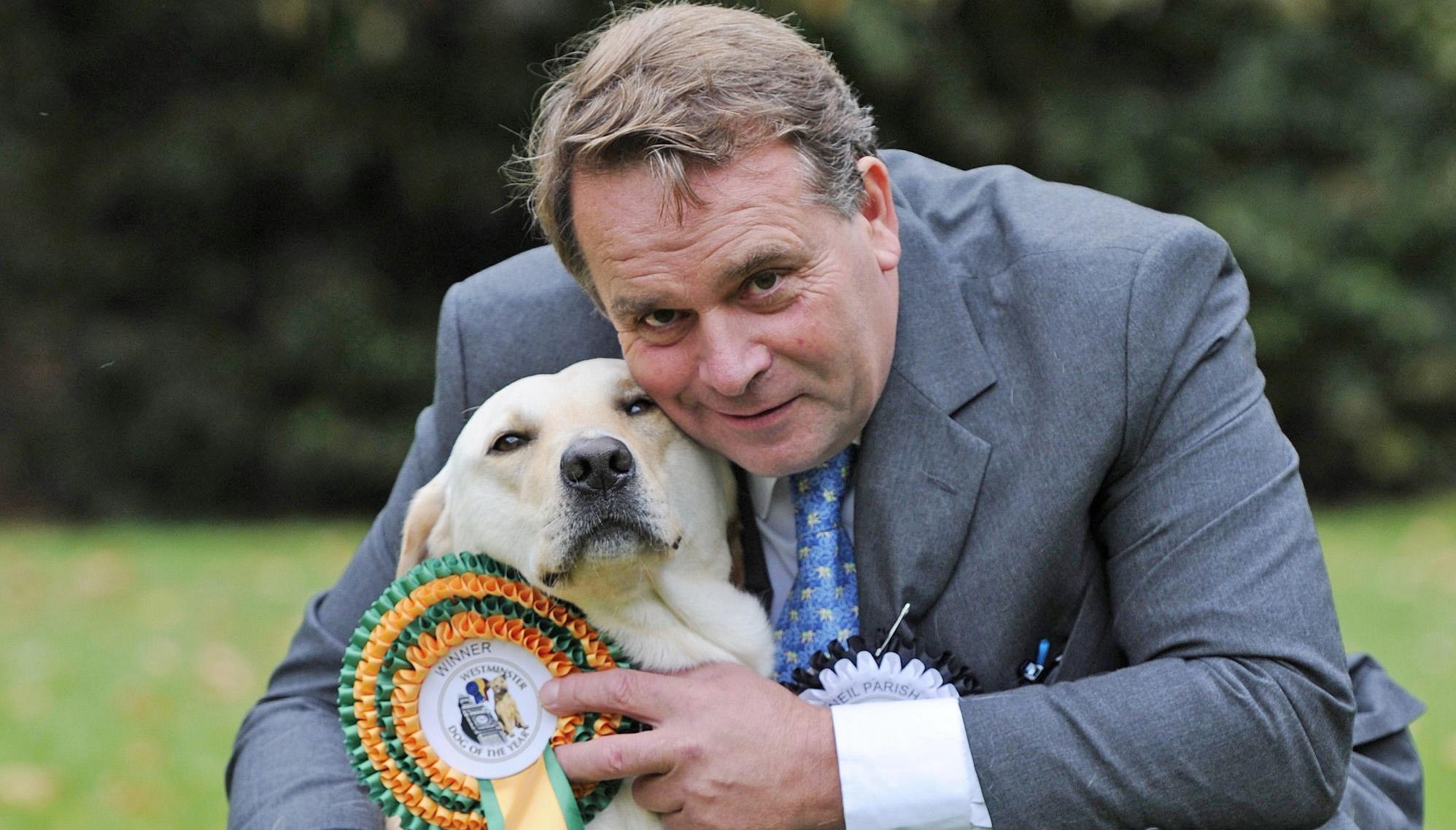 Conservative MP for Tiverton and Honiton Neil Parish and his 4-year-old Labrador Wilberforce, the winner of the Westminster Dog of the Year competition pictured at Victoria Tower Gardens in London.