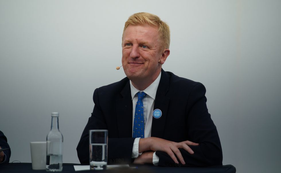 Conservative Party chairman Oliver Dowden wearing a Tory Scum badge during the Conservative Party Conference in Manchester