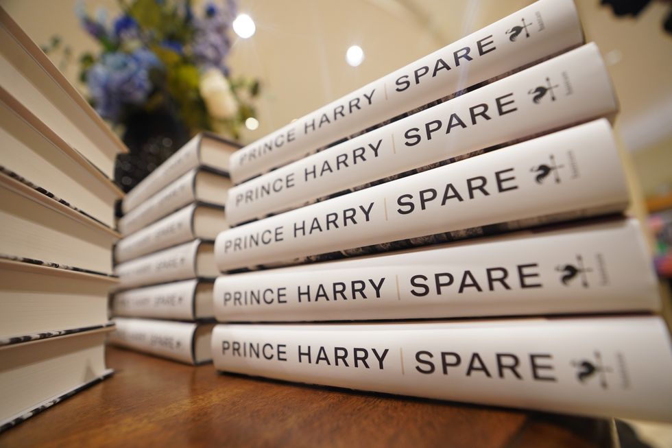 Copies of Prince Harry's Book, Spare, lay on a book shop table