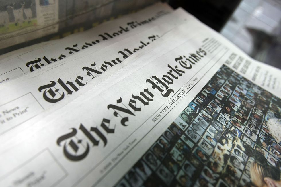 Copies of the New York Times sit for sale in a rack