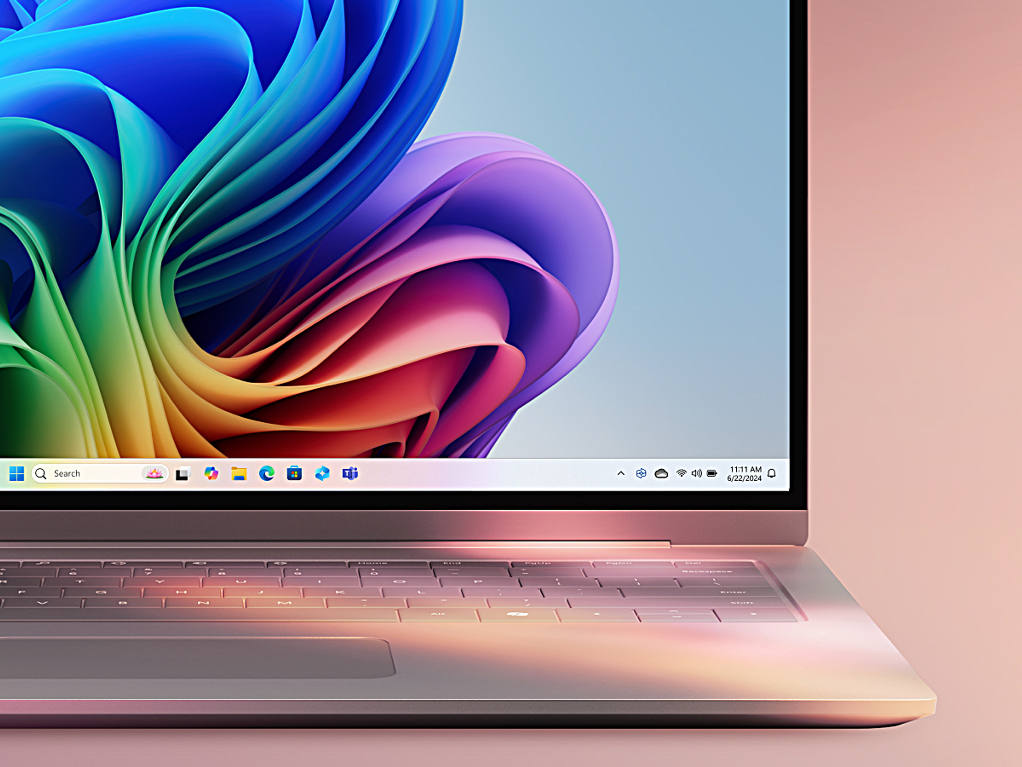 copilot plus pc pictured with a colourful background and windows 11 wallpaper