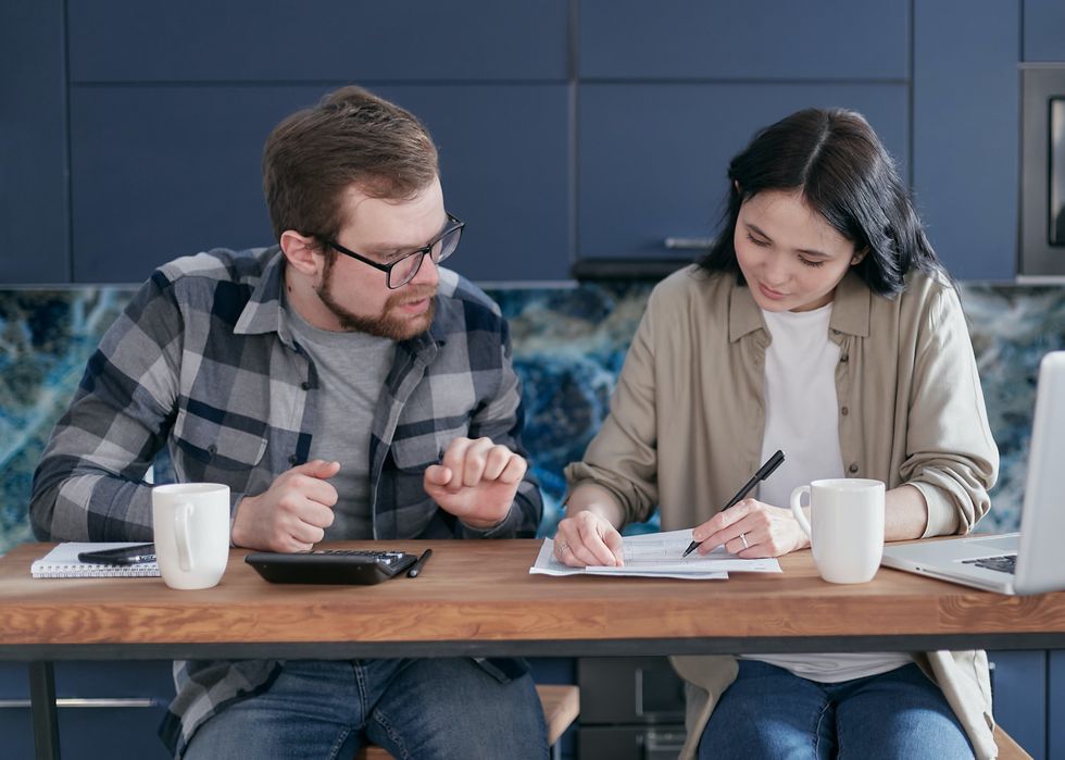 Couple at kitchen table sorting finances
