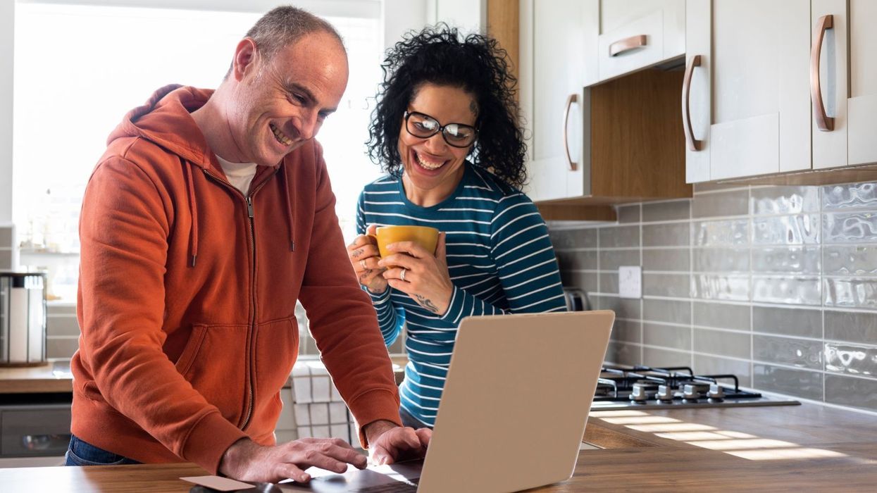 Couple at laptop smiling