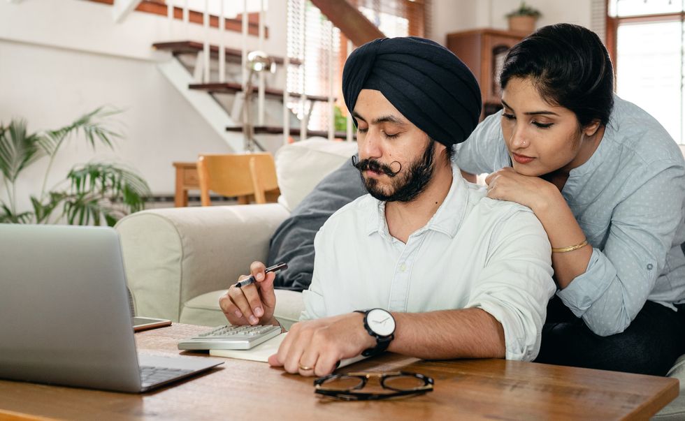 Couple at living room table sorting finances