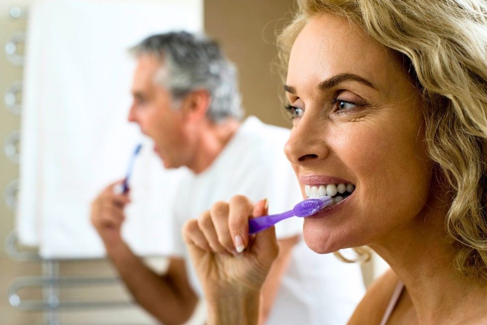 COUPLE BRUSHING TEETH