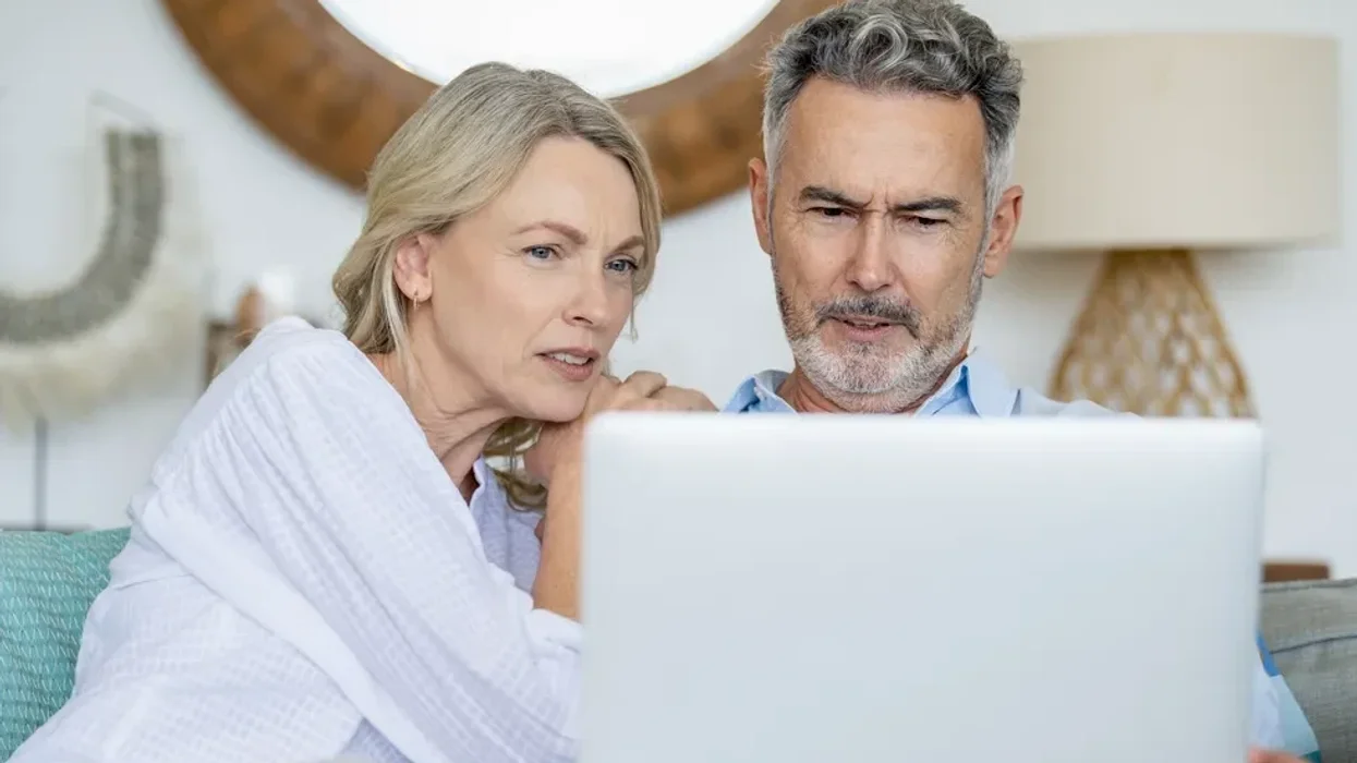 Couple confused looking at laptop