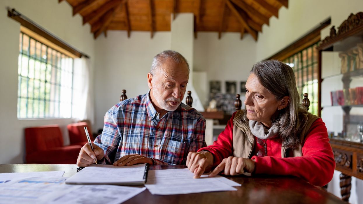 Couple look at finances at dining room table