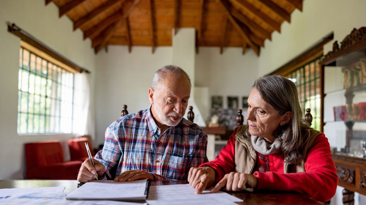 Couple look at finances at dining room table
