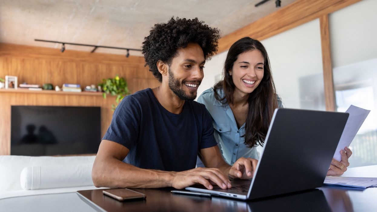 Couple look at finances on laptop