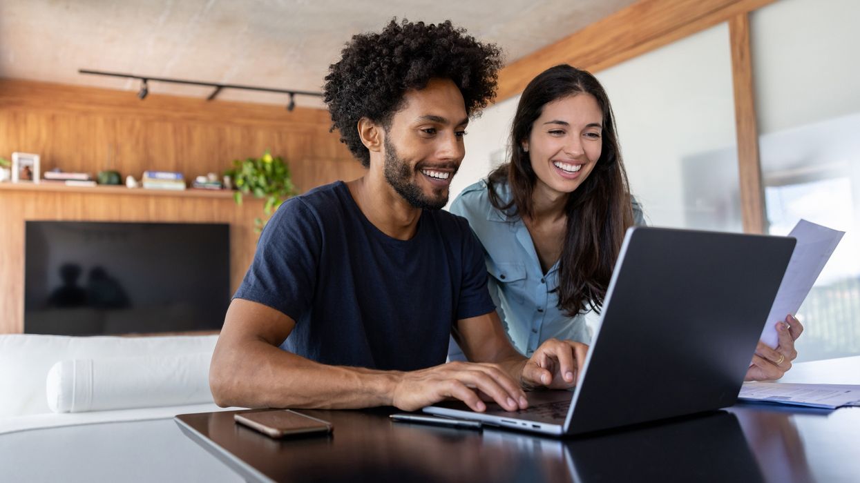 Couple look at finances on laptop