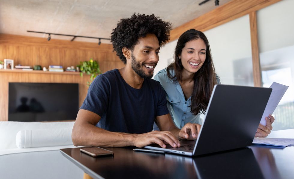 Couple look at finances on laptop