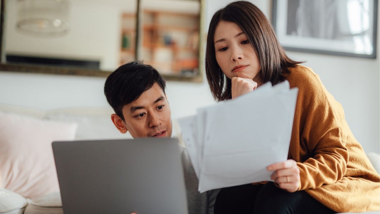 Couple look at laptop and documents