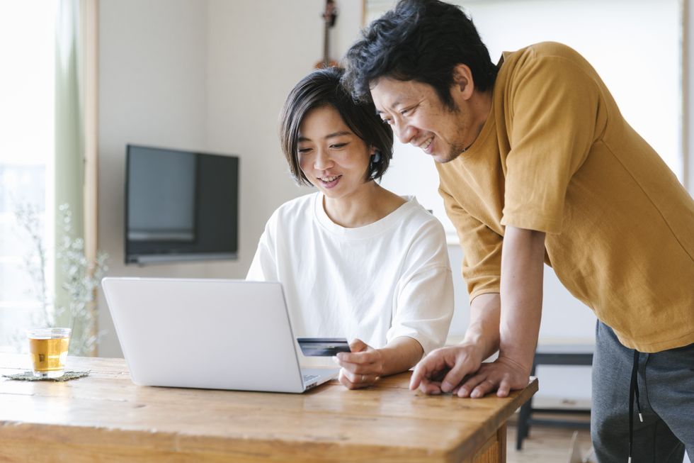 Couple look at laptop together