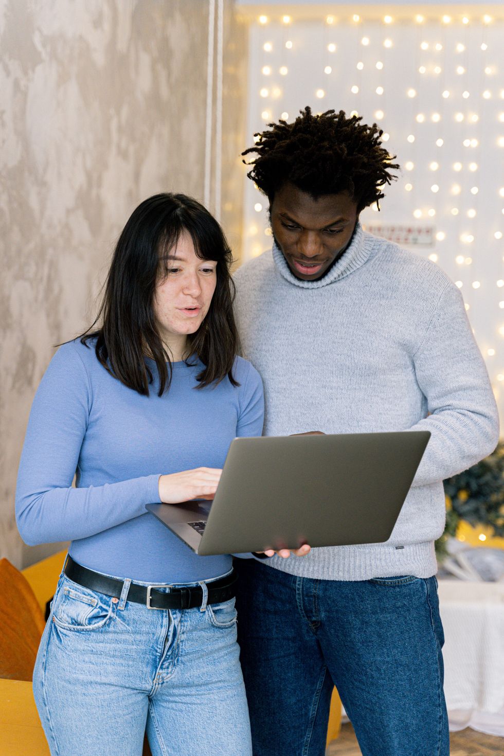 Couple look at laptop