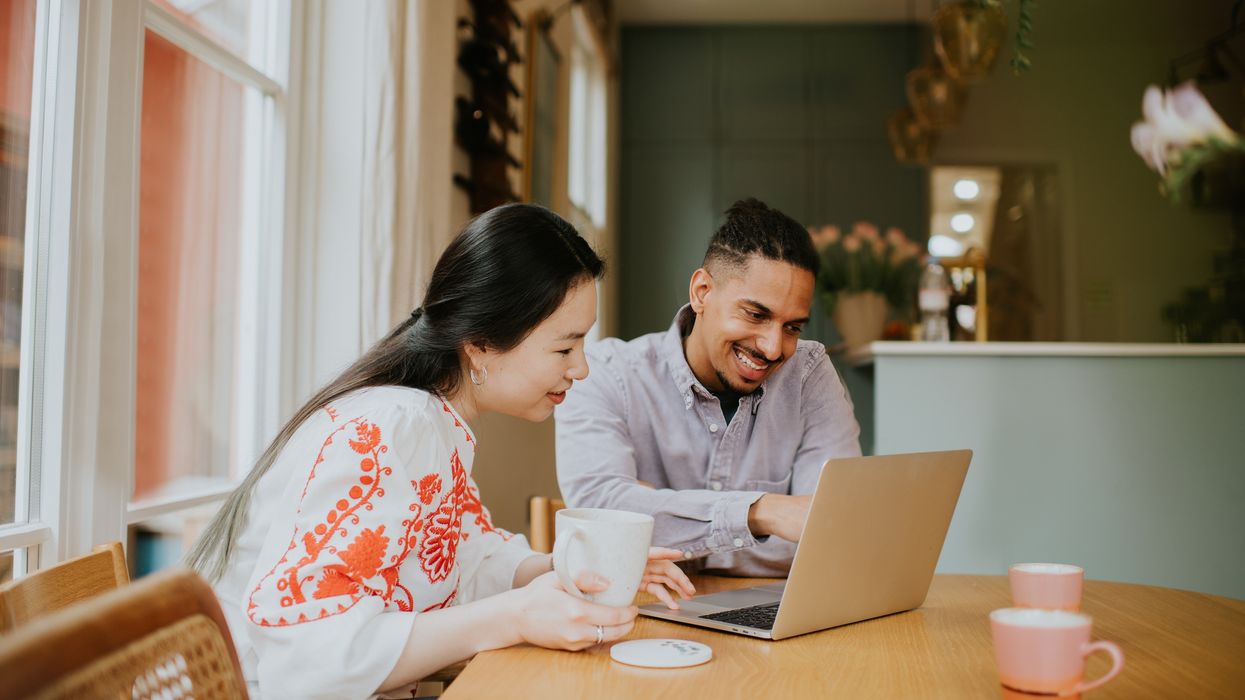 Couple look at laptop