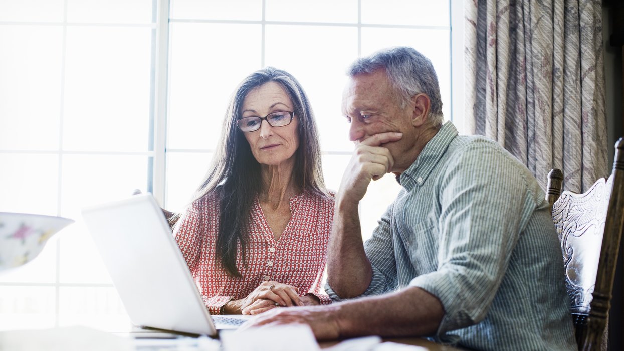 Couple look at laptop