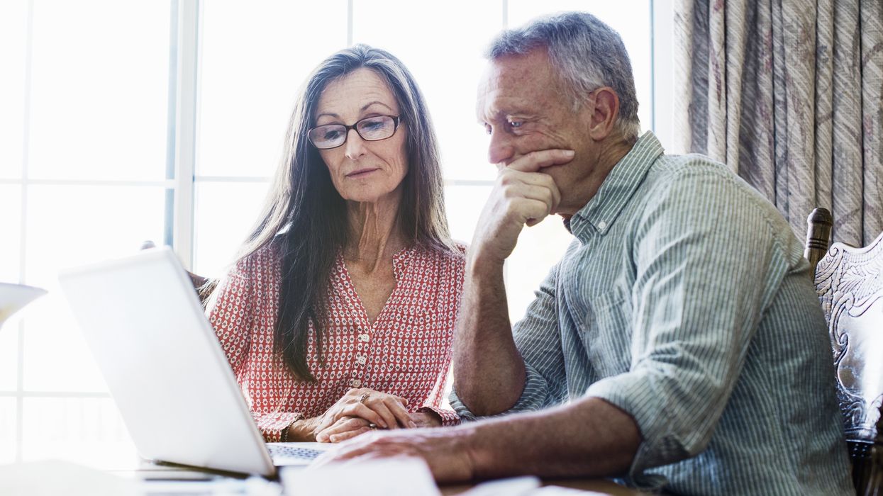 Couple look at laptop