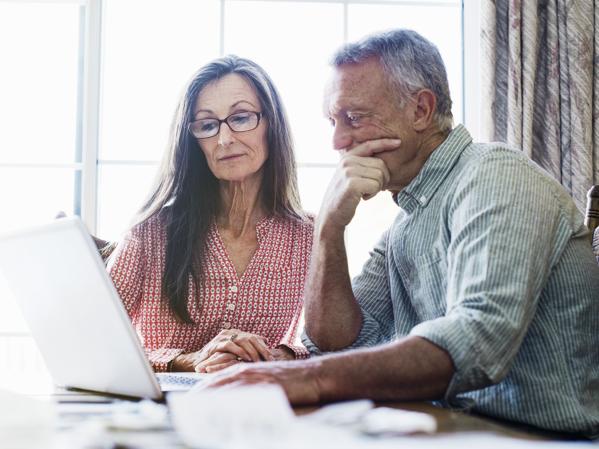 Couple look at laptop