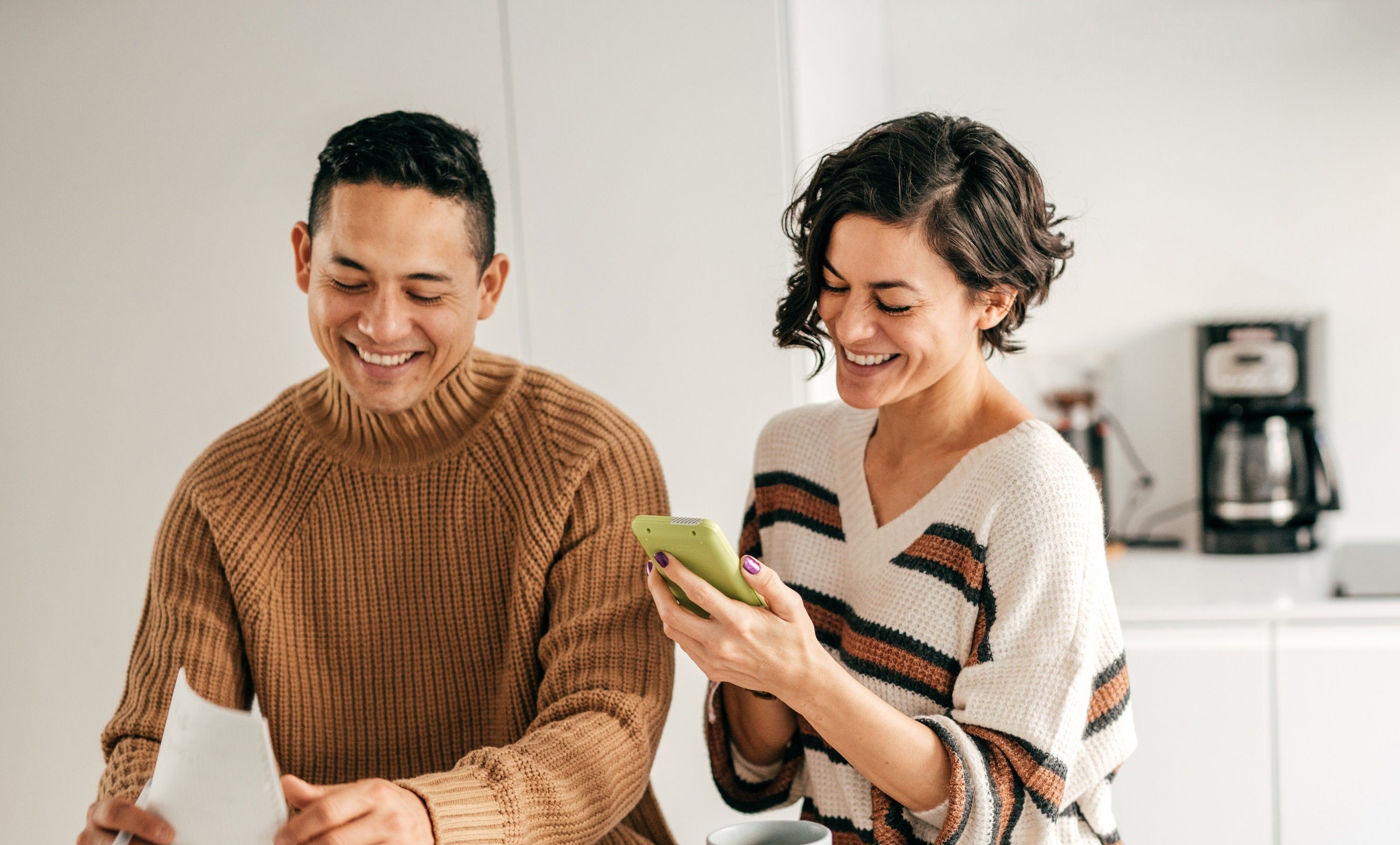 Couple look at phone and documents