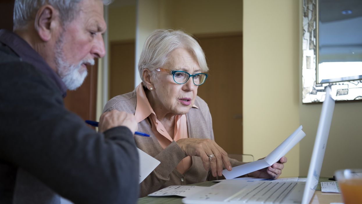 Couple look at statement and laptop