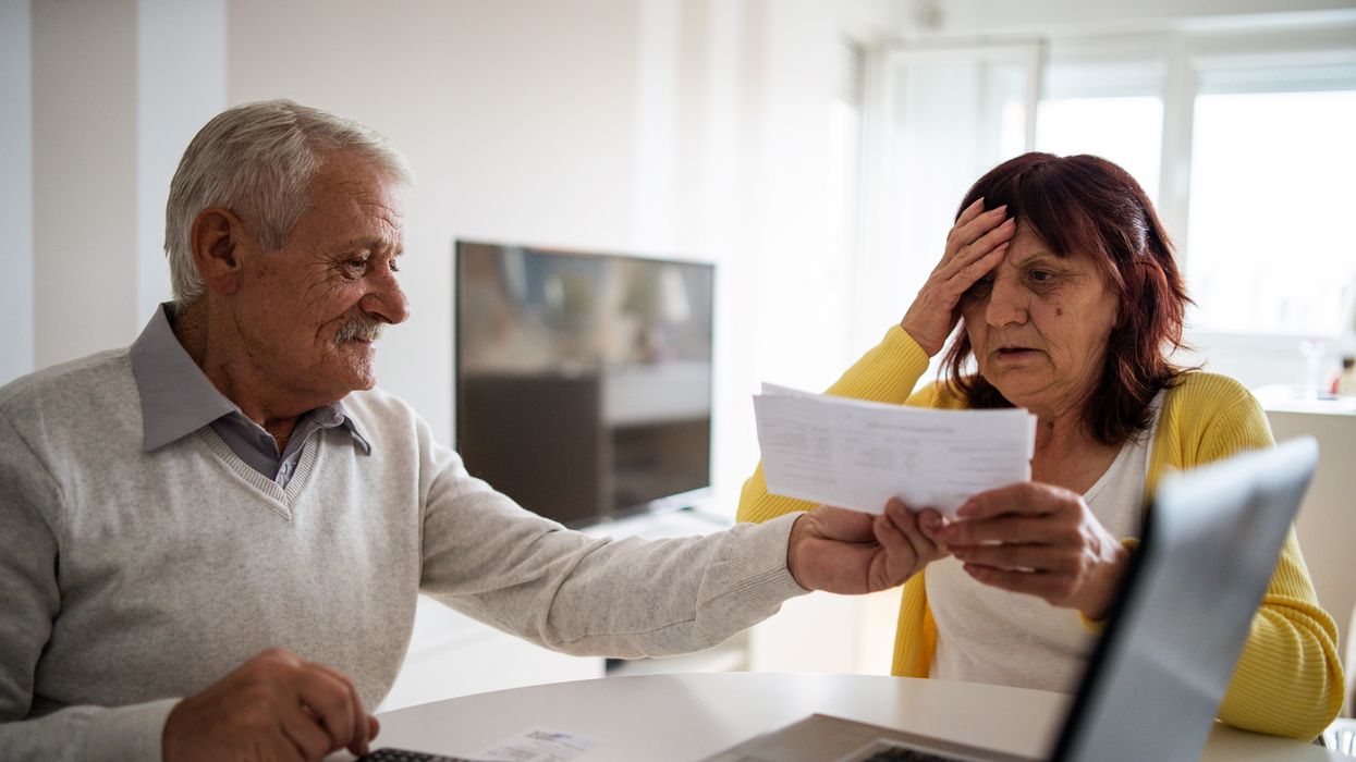 Couple look worried at documents