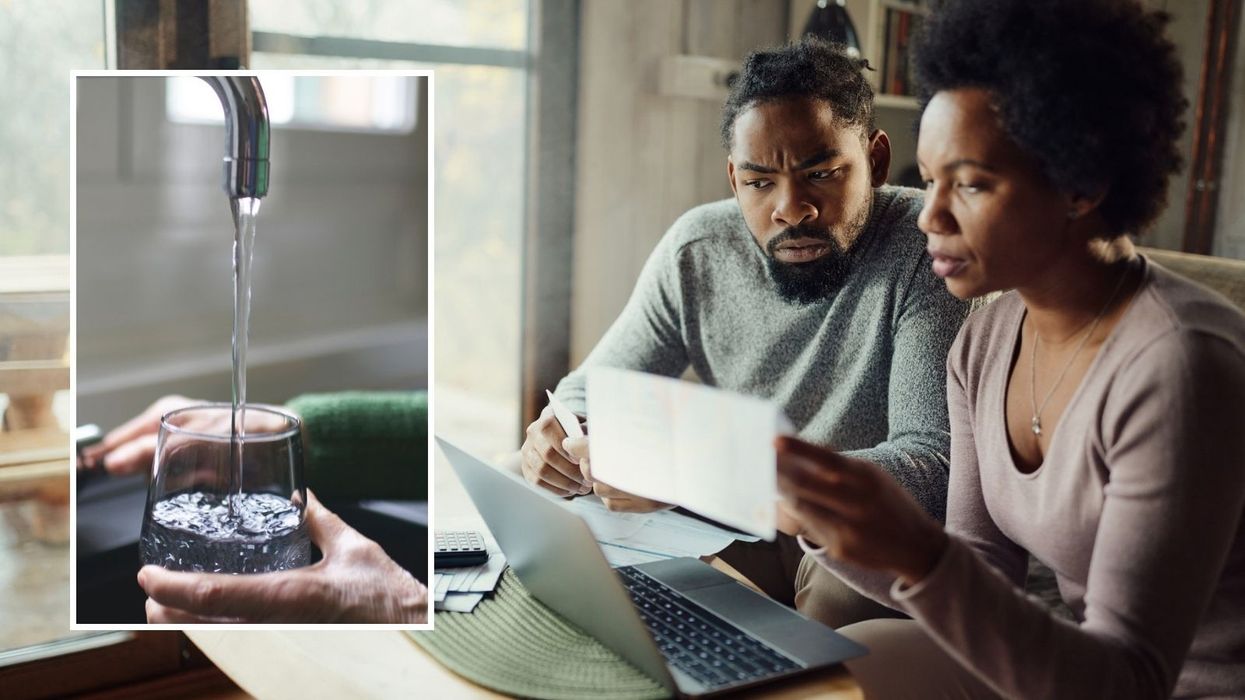 Couple looking at bill and water being poured out of a tap