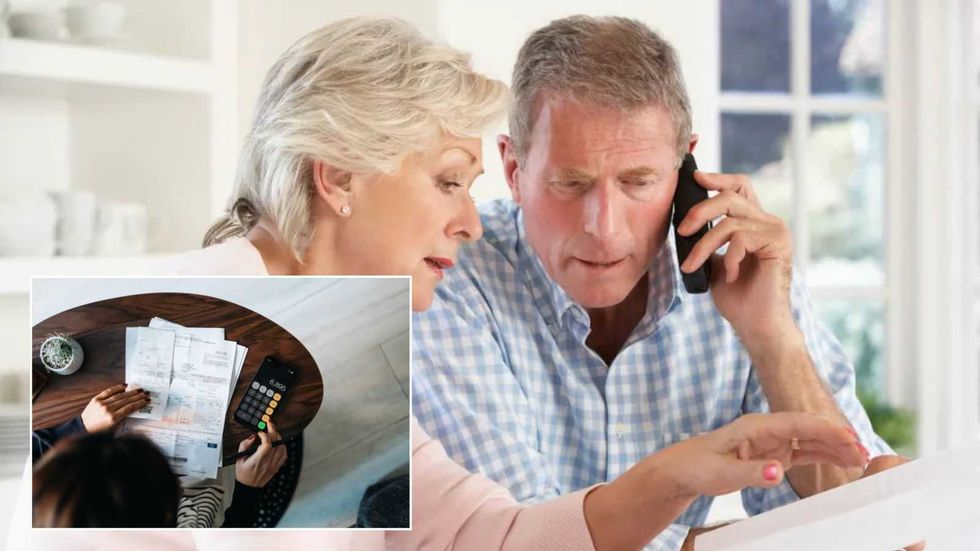 Couple looking at bill stressed