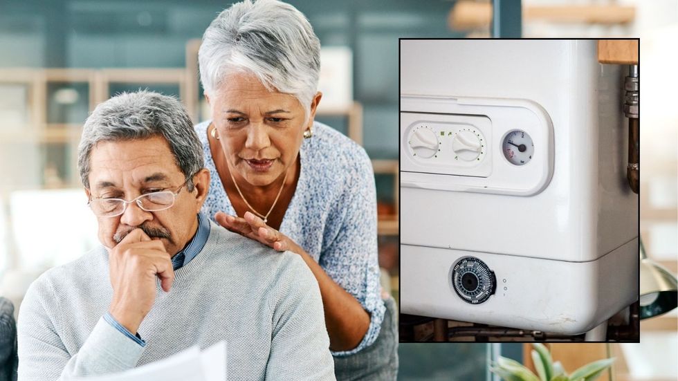 Couple looking at bills and boiler
