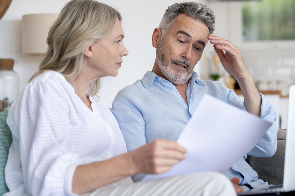 Couple looking at documents confused
