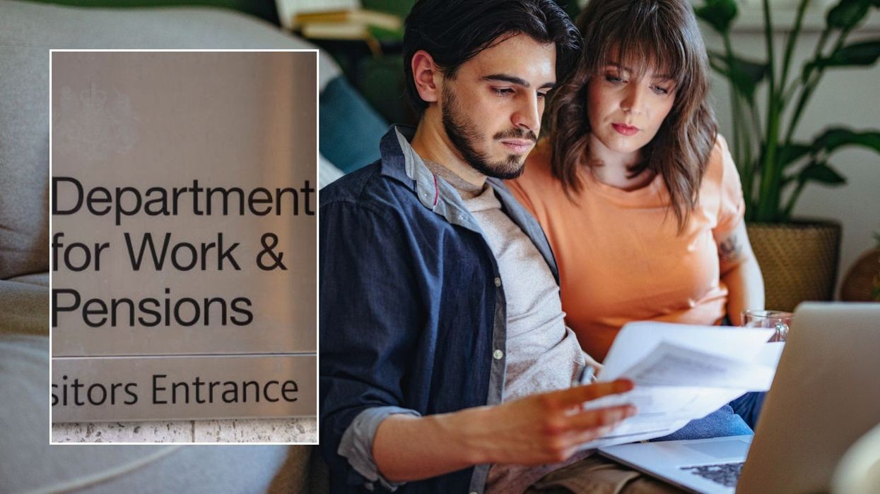 Couple looking at letter and DWP sign