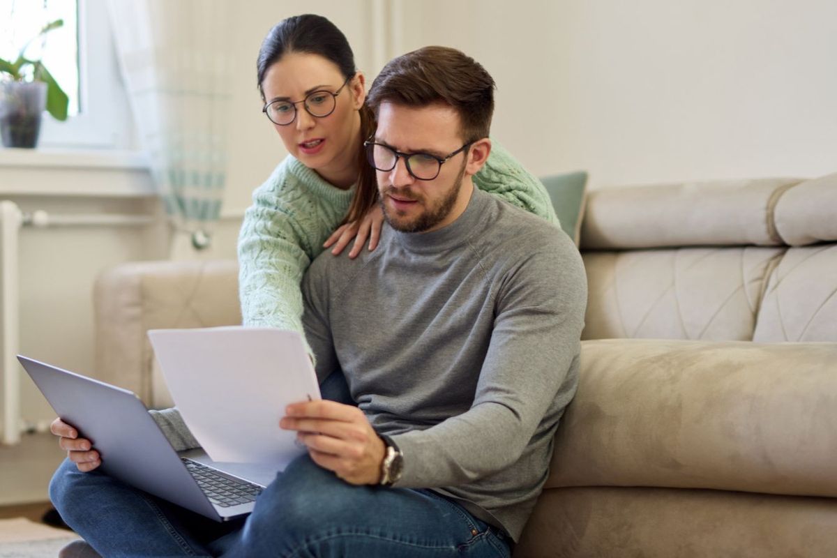 Couple looking worried at documents
