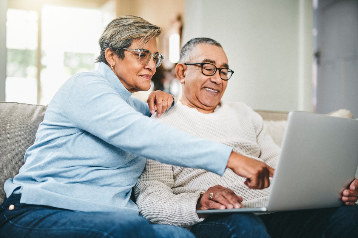 Couple looks at laptop